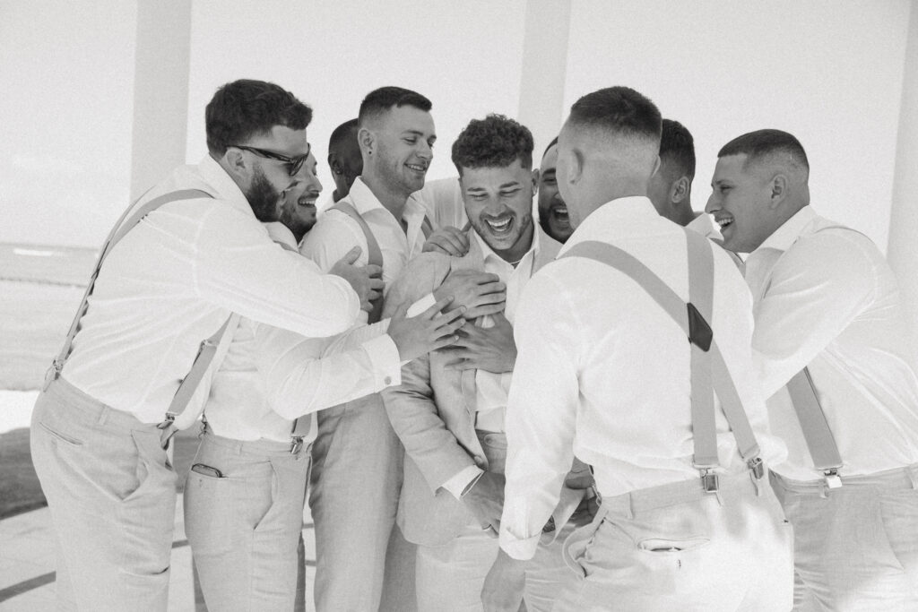 groomsmen hanging out with groom at destination wedding