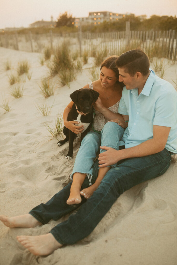 couple in sand with their dogs in New Jersey