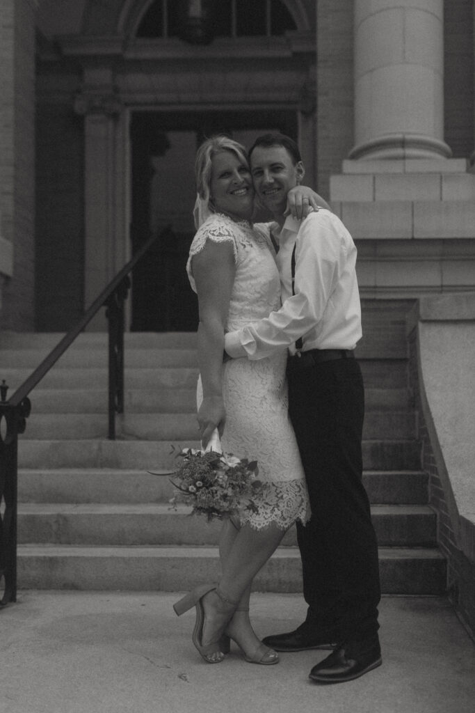 bride and groom smiling for NJ elopement outside courthouse