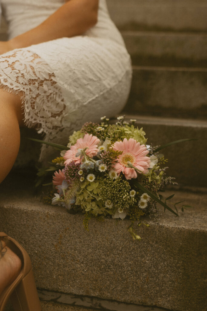 pink and green summer elopement bouquet of flowers on the steps of NJ city hall