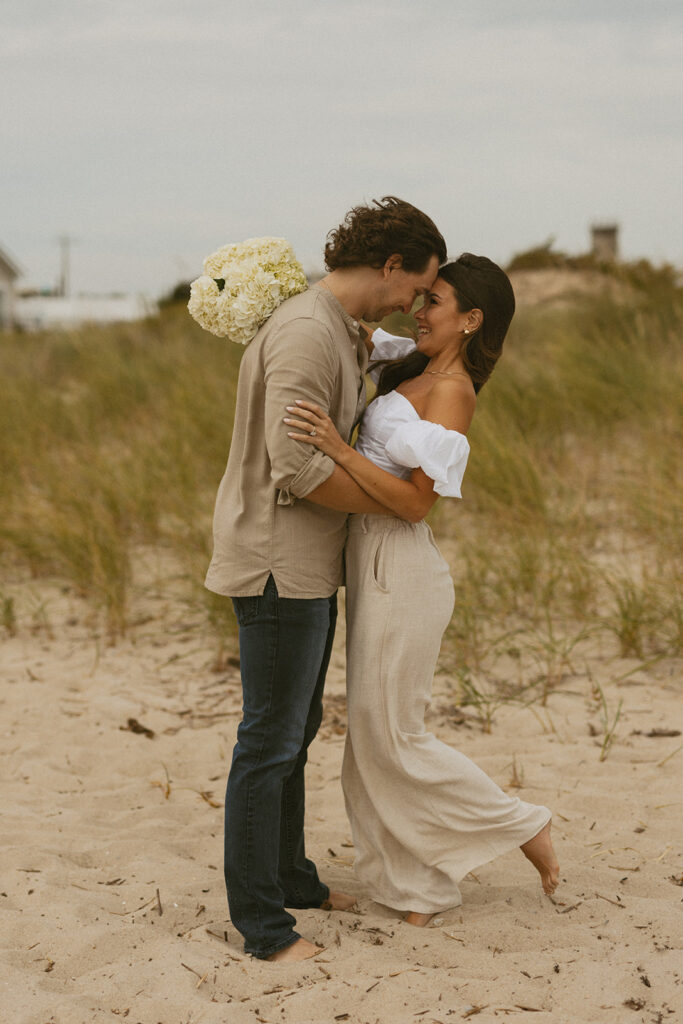 Couples standing on the beach on Sunset Beach in NJ for engagement photos